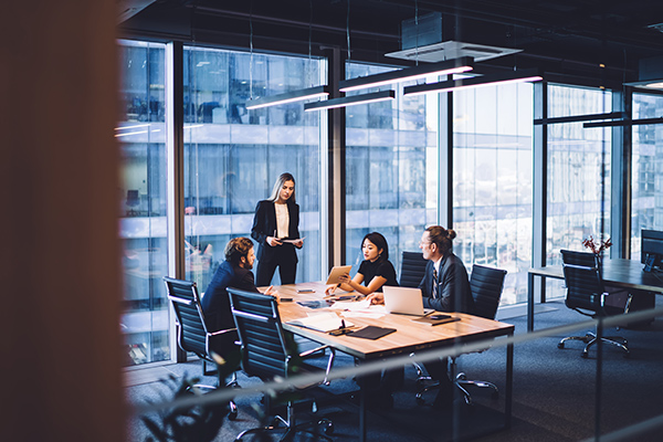 People collaborating around a desk in a modern office building