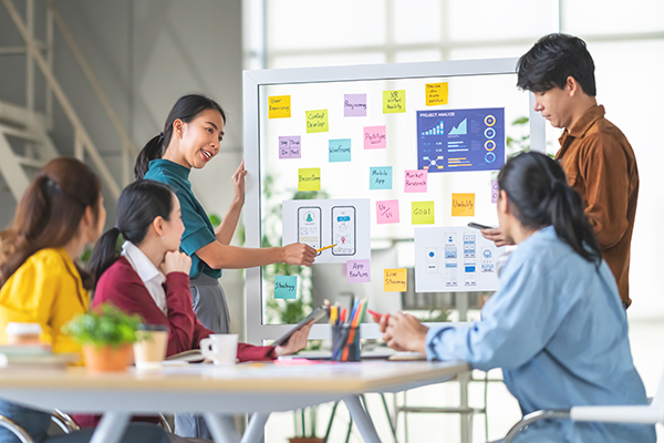 People collaborating around a desk in a modern office building