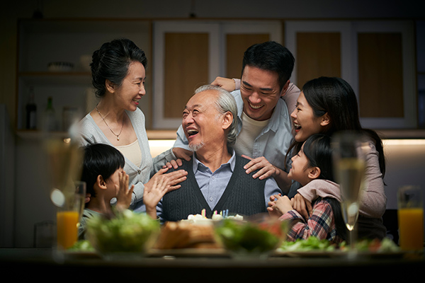 A family enjoying a birthday celebration around a table